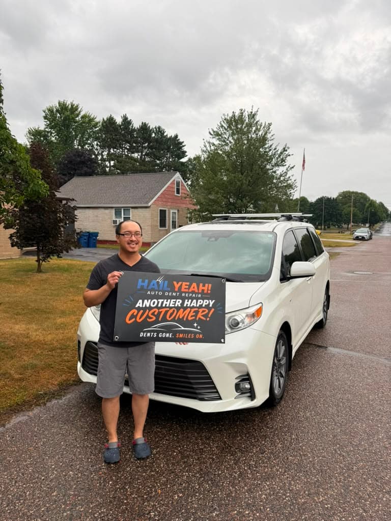 M. Alvarez, Wausau, WI standing with their repaired vehicle